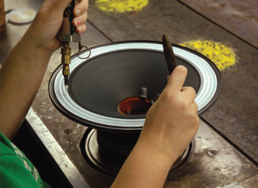 An assembly technician in Eminence’s Kentucky factory applies an edge treatment.